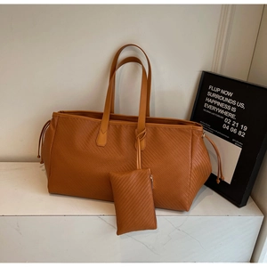 Détail du sac cabas marron foncé à texture tissée avec cordon et pochette assortie