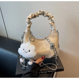 Détail du sac hobo avec poignée plissée, chaîne argentée et breloque nuage en peluche