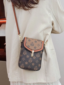 Retro monogram mini crossbody bag in brown faux leather with gold buckle on model