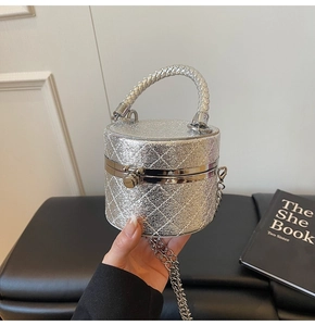 Detailed shot of silver quilted mini bag with woven handle and elegant metal chain strap