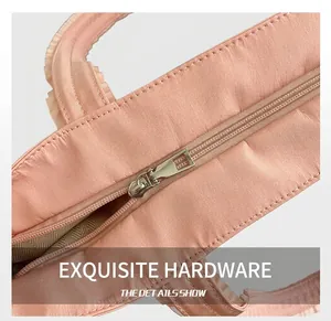 Detailed close-up of pink tote bag showing smooth nylon fabric and silver metal zipper