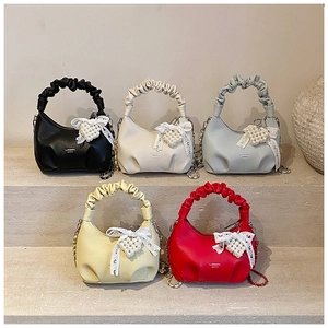 Collection of half-moon mini bags with pleated handles and pearl heart charms