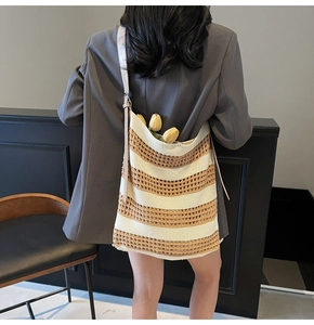Detail of woven beach tote showing beige and brown contrast stripes with hollow mesh texture