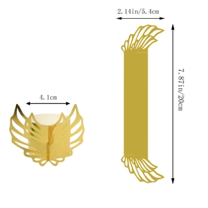 Macro detail of gold angel wing paper napkin rings with precise hollow-out feather texture