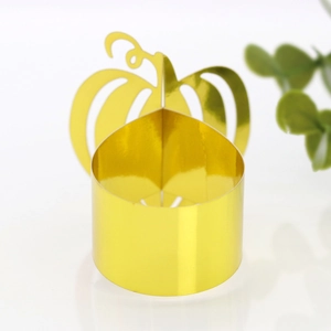 Close-up of golden pumpkin napkin ring with polished metal finish for festive table setting
