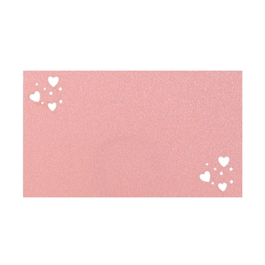 Macro detail of pink glitter texture card with white heart and polka dot patterns