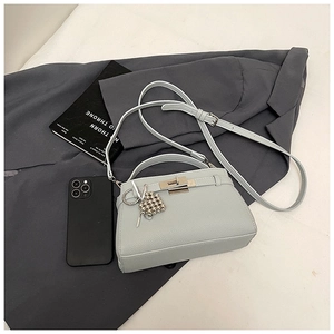 Overhead view of a light blue lychee pattern handbag with silver hardware and shoulder strap