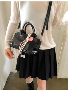 Chic black glossy patent leather bucket bag with pink heart charm and top handles