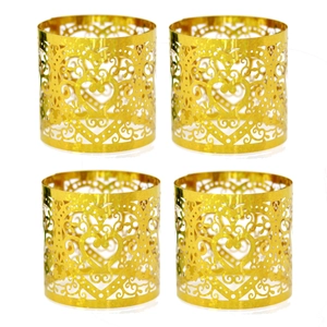 Macro view of 4-piece laser-cut gold glitter heart napkin rings for wedding table decor
