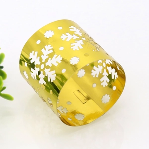 Detailed view of golden Christmas snowflake napkin ring with intricate laser cut design