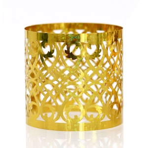 Elegant gold laser-cut napkin ring with intricate vine patterns for wedding table decor