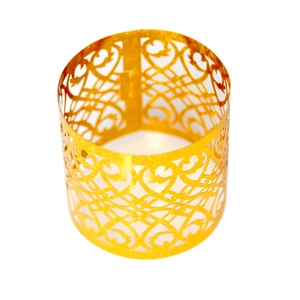 Close-up of golden hollow vine pattern napkin ring with intricate metal floral details