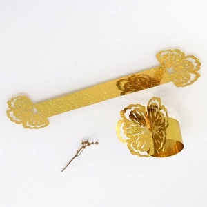 Close-up of golden glitter laser-cut floral napkin rings for wedding table decoration