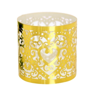 Detail of laser-cut gold paper napkin ring with heart pattern and pearlescent finish