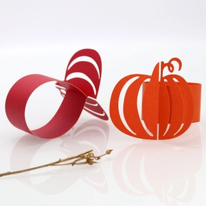 Golden Halloween pumpkin paper napkin rings for festive restaurant table decor