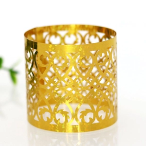 Macro detail of gold laser-cut napkin ring with sparkling glitter and heart motifs