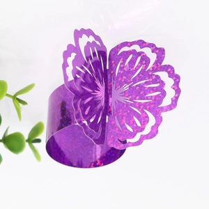 Detail of glitter purple butterfly napkin ring with hollow laser cut flower design
