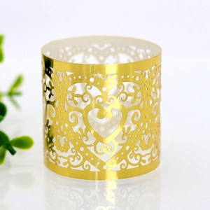 Macro detail of laser-cut golden heart napkin ring with elegant floral patterns
