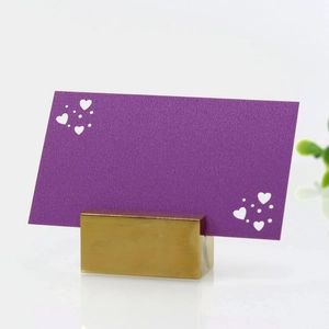 Detail of a purple textured heart place card with a brushed gold metal holder