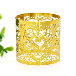 Detail of laser-cut heart pattern on gold napkin ring for wedding table decor