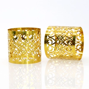 Close-up of golden glitter hollow-out napkin rings with elegant floral vine patterns