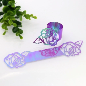 Macro shot of laser-cut rose hollow napkin ring with iridescent metallic finish