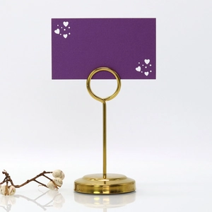 Elegant gold metal heart table number holder with a purple laser cut card and dry flower