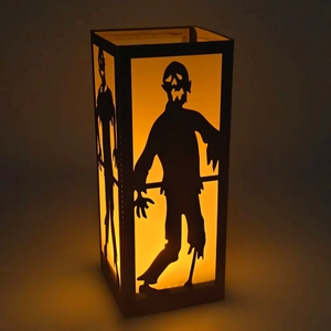 Halloween black lantern with cutout zombie silhouette and warm LED glowing light