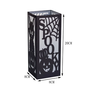 Macro detail of Halloween spooky black paper lantern with laser-cut spider web and cat