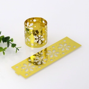 Close-up of golden mirror snowflake paper napkin rings for elegant Christmas table decor