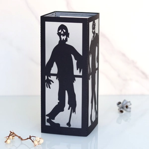 Detail of Halloween black lantern with laser-cut zombie silhouette and white panels
