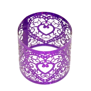 Detail of purple hollow heart napkin ring with sparkling glitter finish and laser-cut design