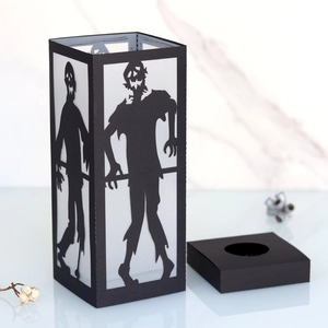 Halloween black paper lantern with laser-cut zombie silhouettes for spooky atmosphere
