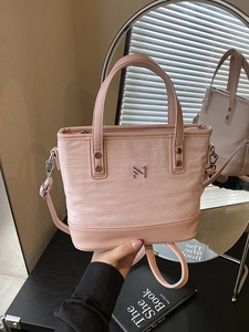 Pink pleated fabric bucket bag with metal logo and adjustable strap for women