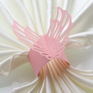Detail of pink pearlescent butterfly napkin ring with laser-cut hollow wing patterns