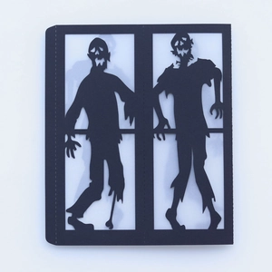 Laser-cut zombie silhouettes for Halloween lanterns in black cardboard cutout detail