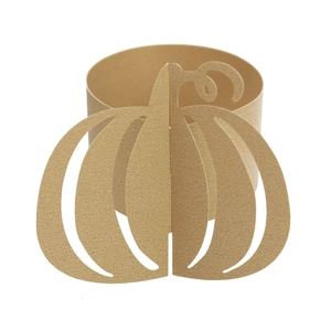 Detailed view of golden glitter paper napkin ring with laser-cut pumpkin design for Halloween