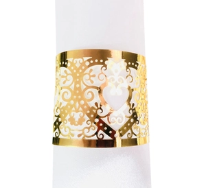 Detailed view of golden laser-cut napkin ring with intricate heart and vine patterns