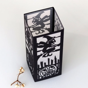 Detailed view of Halloween paper lantern featuring laser-cut witch and pumpkin patterns