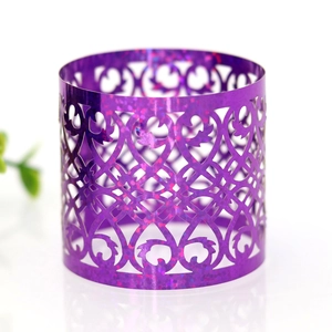Macro shot of purple hollow napkin ring with holographic glitter and laser-cut patterns
