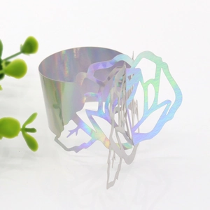 Macro detail of laser-cut rose hollow napkin ring with colorful iridescent coating