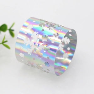 Macro shot of iridescent laser-cut snowflake napkin ring with holographic mirror finish