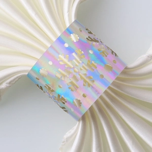 Macro detail of holographic snowflake napkin ring with laser-cut hollow design