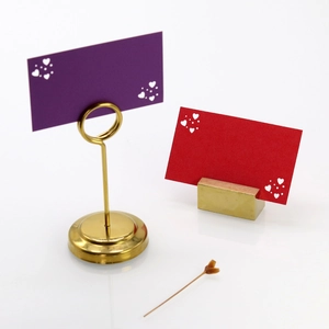 Detailed view of golden heart card holders with high-gloss finish and hollow card designs