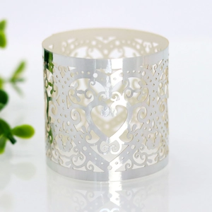 Detail of silver laser-cut heart pattern napkin ring with elegant floral hollow design