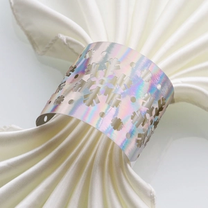 Holographic snowflake napkin ring detail on white satin napkin for Christmas party decor