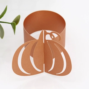 Detailed laser-cut pumpkin napkin ring in orange pearlescent finish for festive table setting