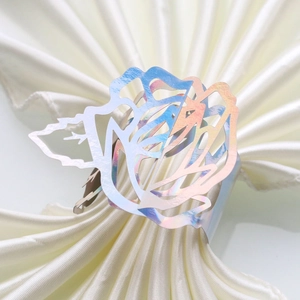Macro detail of iridescent rose napkin ring with laser-cut hollowed petals for wedding decor