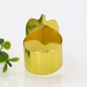 Close-up of golden mirror polished pumpkin napkin ring with a sleek interlocking design