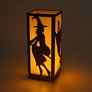 Halloween black witch and ghost silhouette lantern with warm orange glow effect